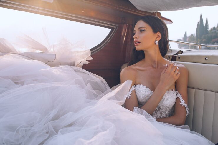 Νυφικό woman wearing white sweetheart-neckline wedding dress inside vehicle